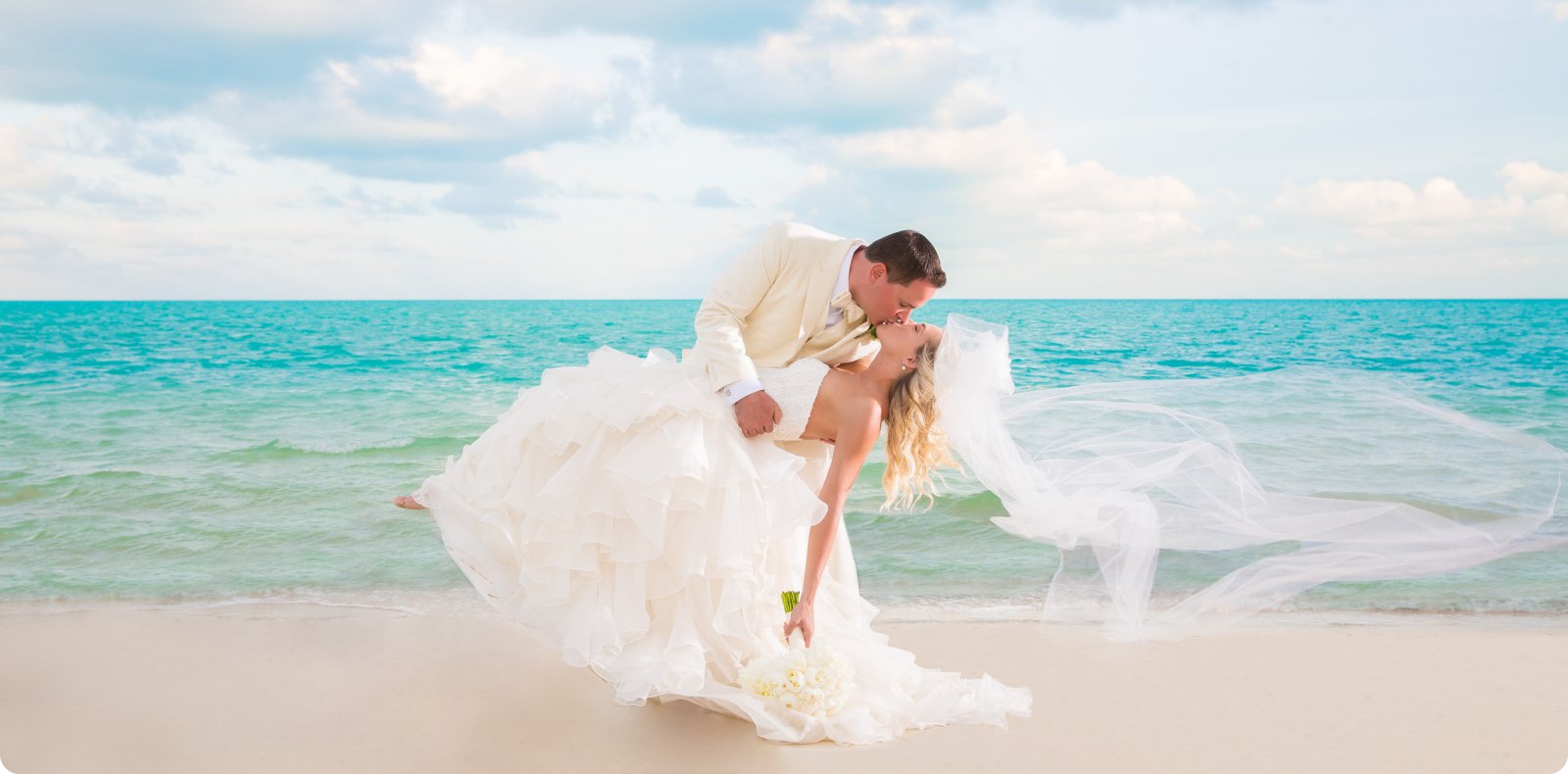 Bride in the turquoise water at sunset