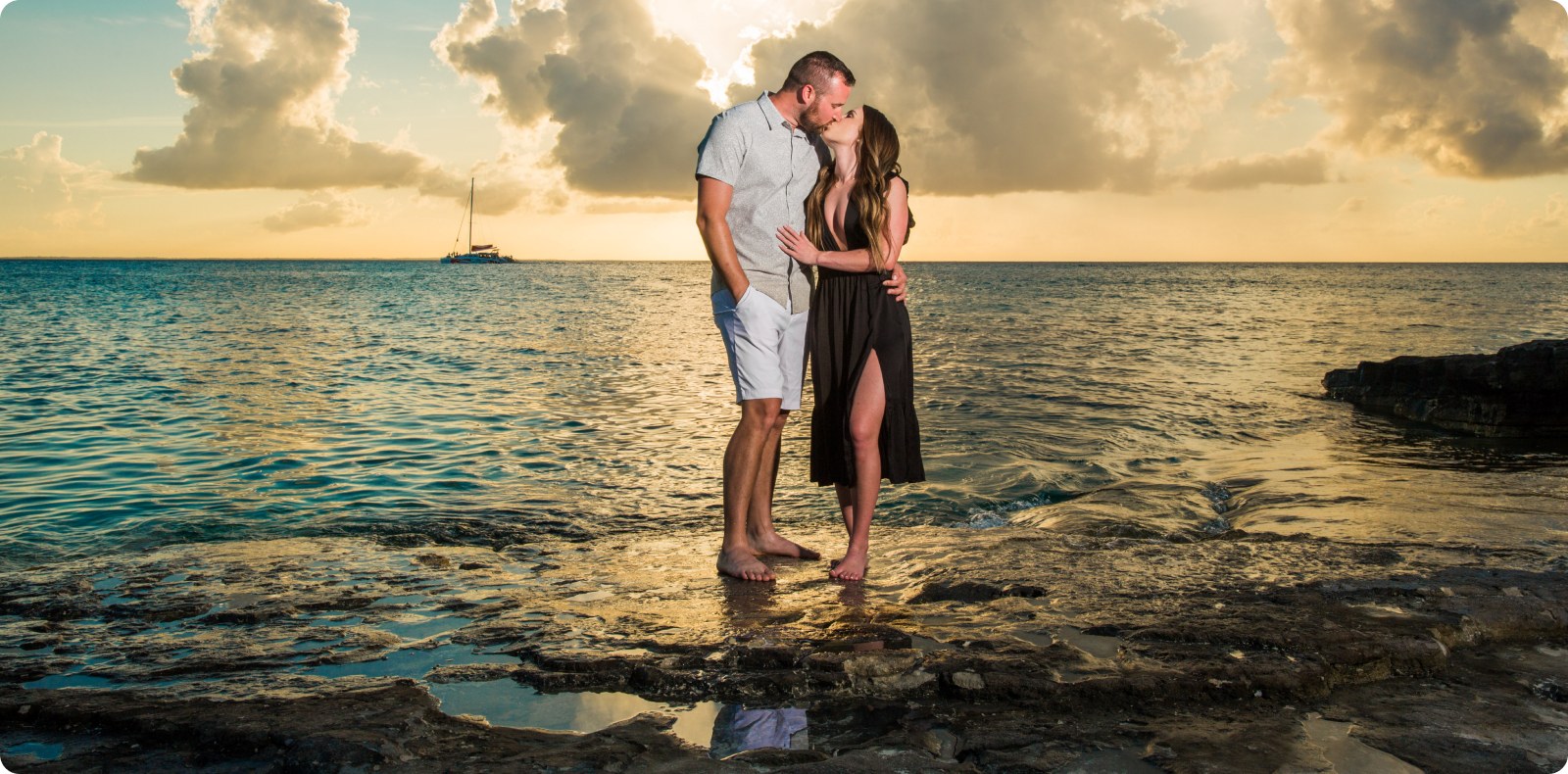 A couple sharing a kiss at sunset on a Turks & Caicos beach