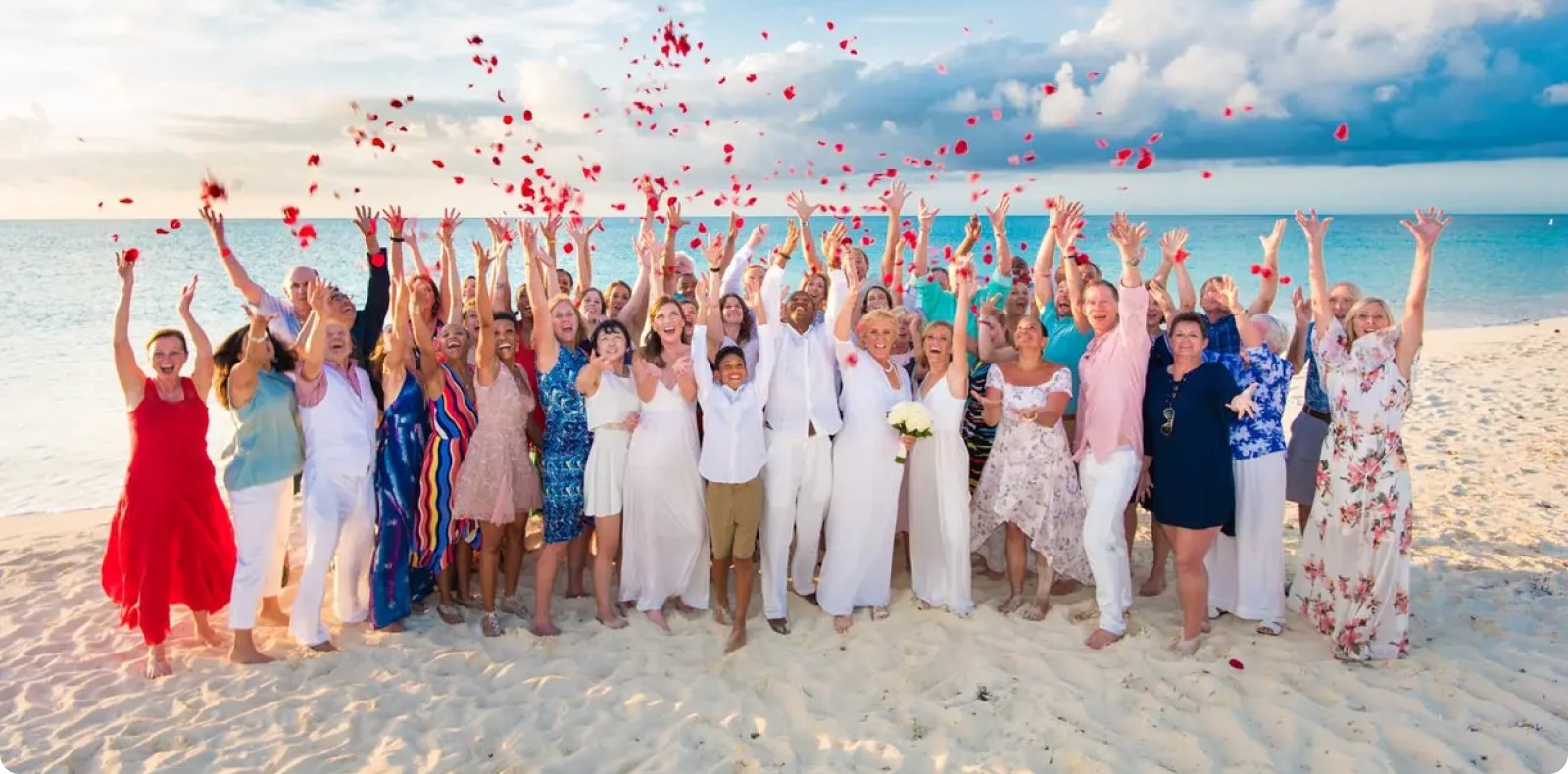 Wedding guests tossing rose petals on a Turks & Caicos beach