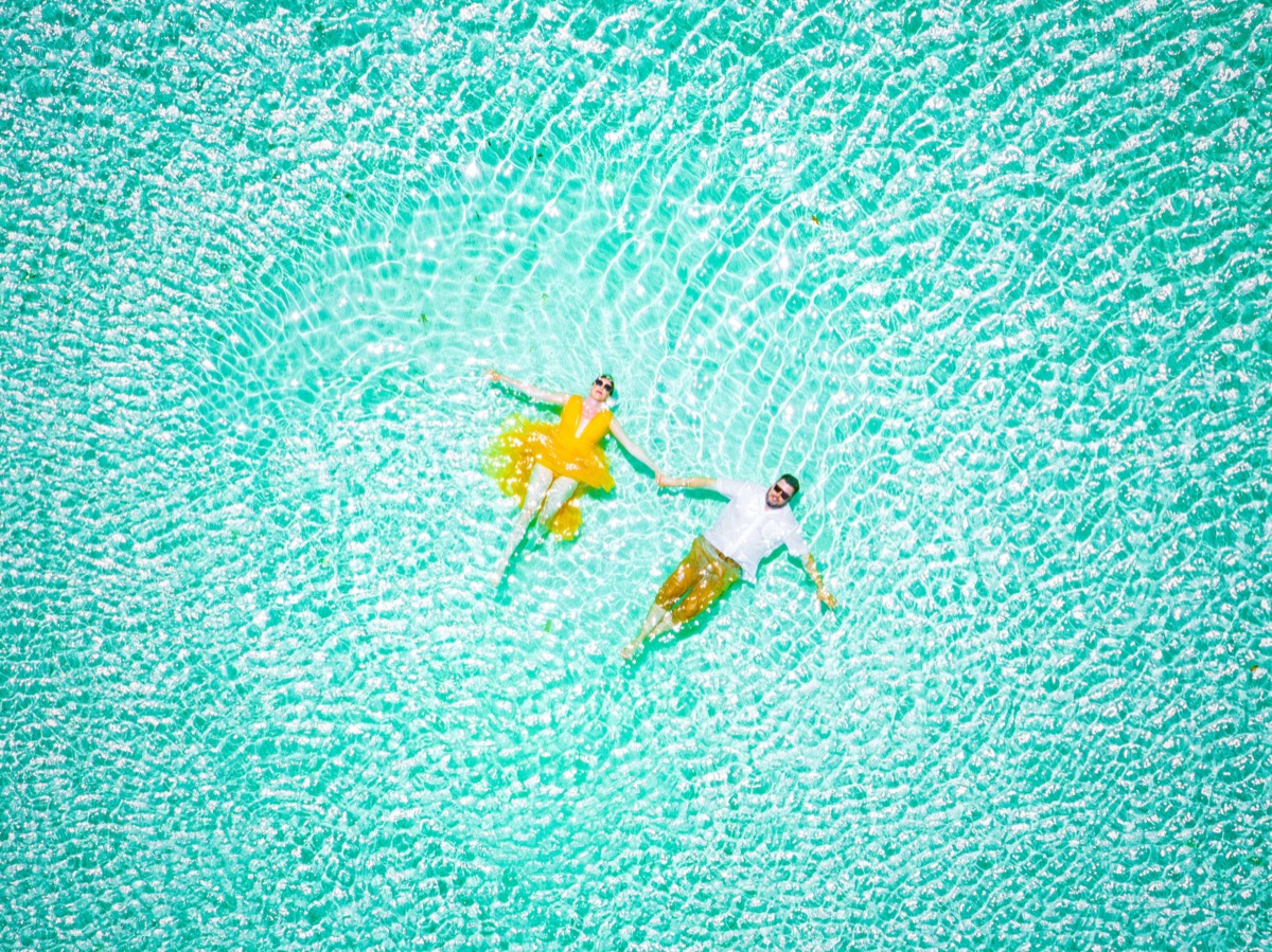 Couple embracing on a Turks and Caicos beach at sunset