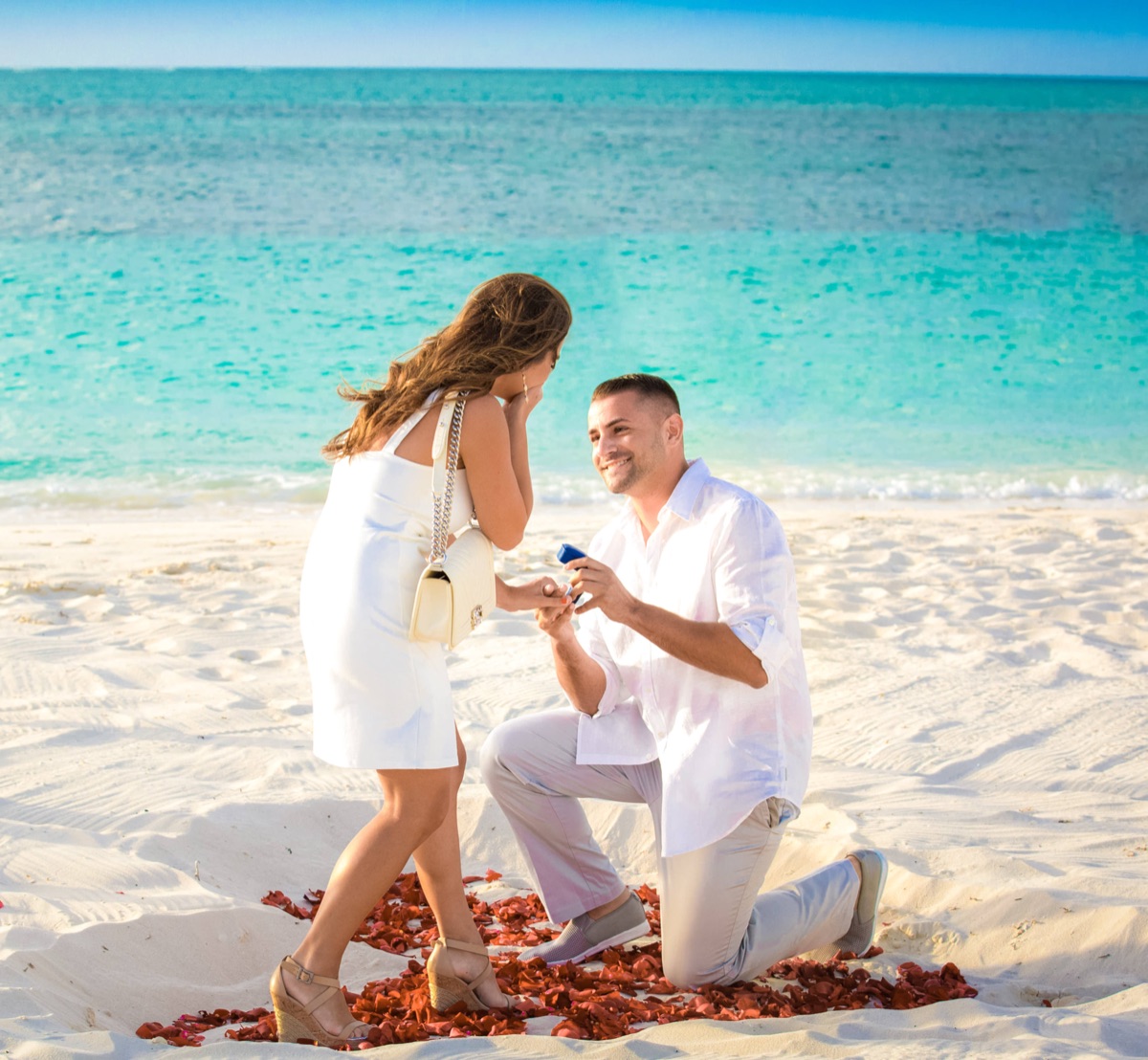Just-engaged couple celebrating on the beach in Turks and Caicos